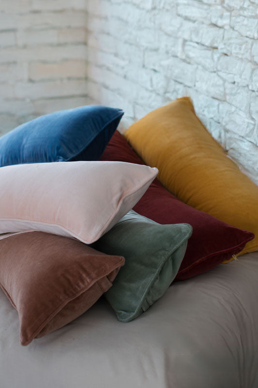 Tierra organic velvet lumbar pillow covers in a variety of colors showcasing plush breathable texture, luxury bedding design, and soft organic fabrics.
