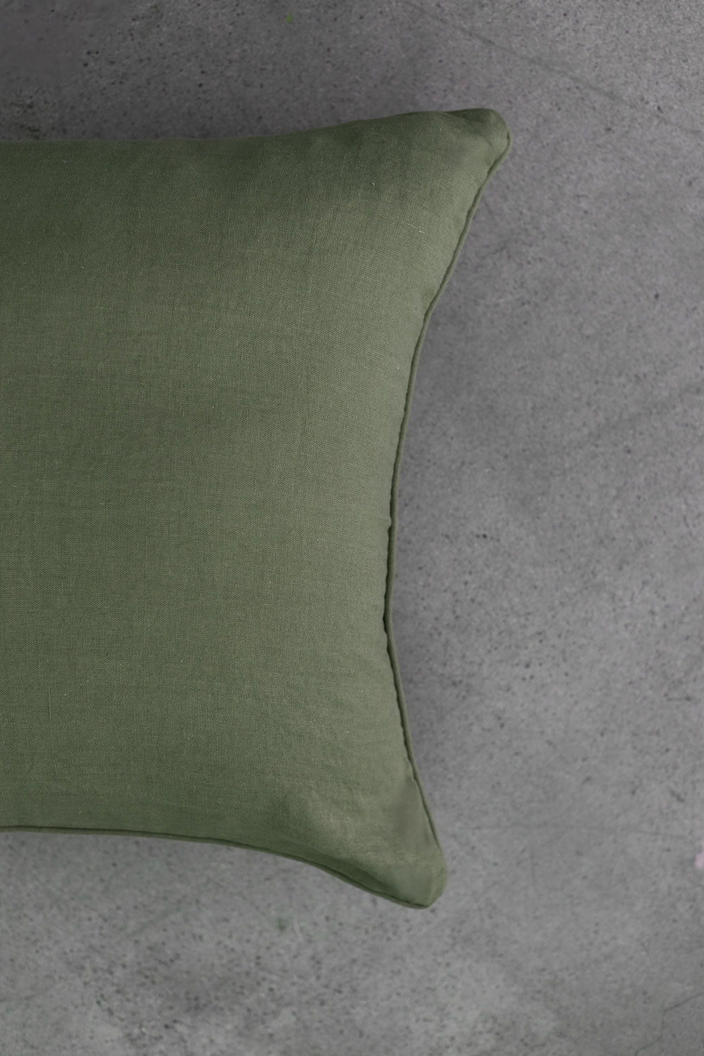 The scene highlights Tierra’s 100% Linen Headboard Cushion Cover through a series of soft, neutral bedroom scenes. It shows a smooth green pillow resting against a muted backdrop, emphasizing the clean, breathable feel of natural linen. 