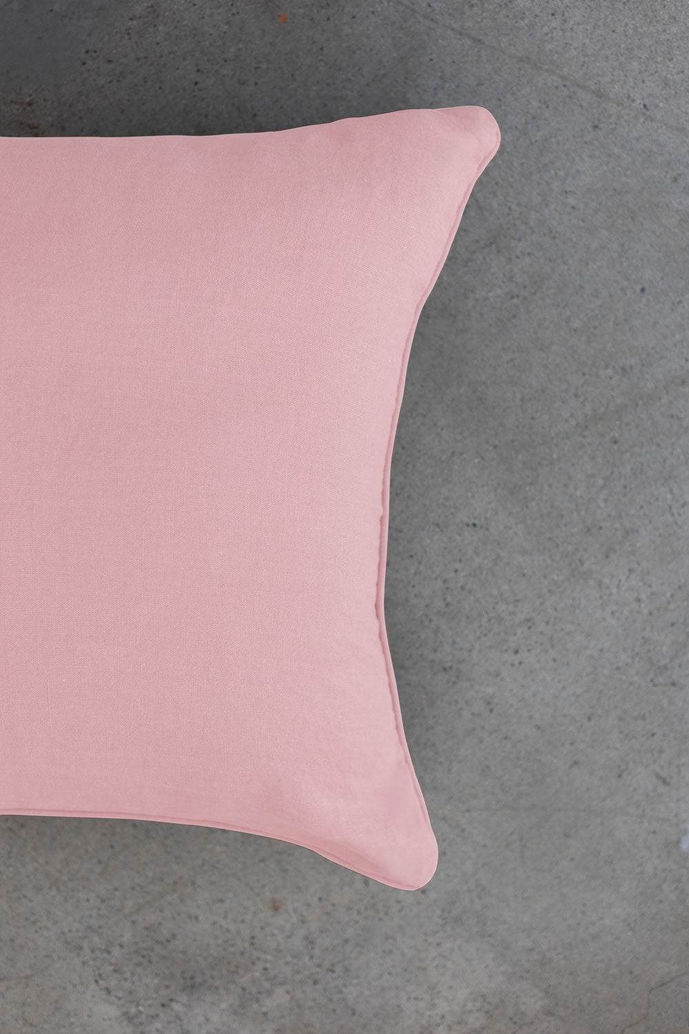 The scene highlights Tierra’s 100% Linen Headboard Cushion Cover through a series of soft, neutral bedroom scenes. It shows a smooth pink pillow resting against a muted backdrop, emphasizing the clean, breathable feel of natural linen. 