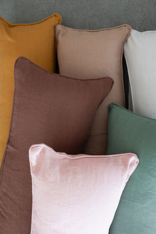 Close-up of 100% linen lumbar pillows in a variety of colors that are beautifully textured for effortless elegance and easy-care luxury bedding.
